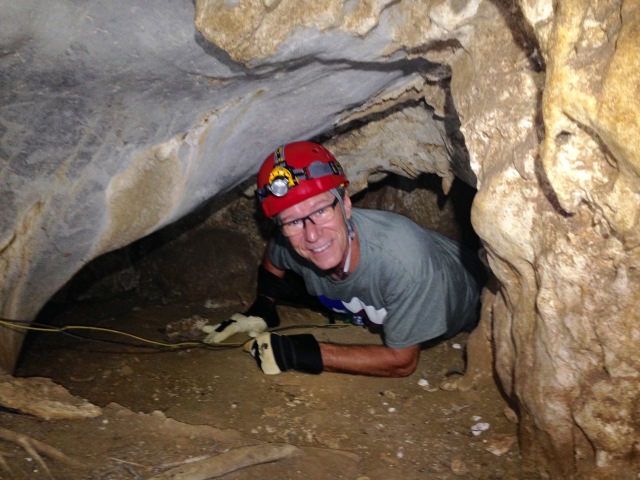 Dennis crawling through a tight space in one of the caves